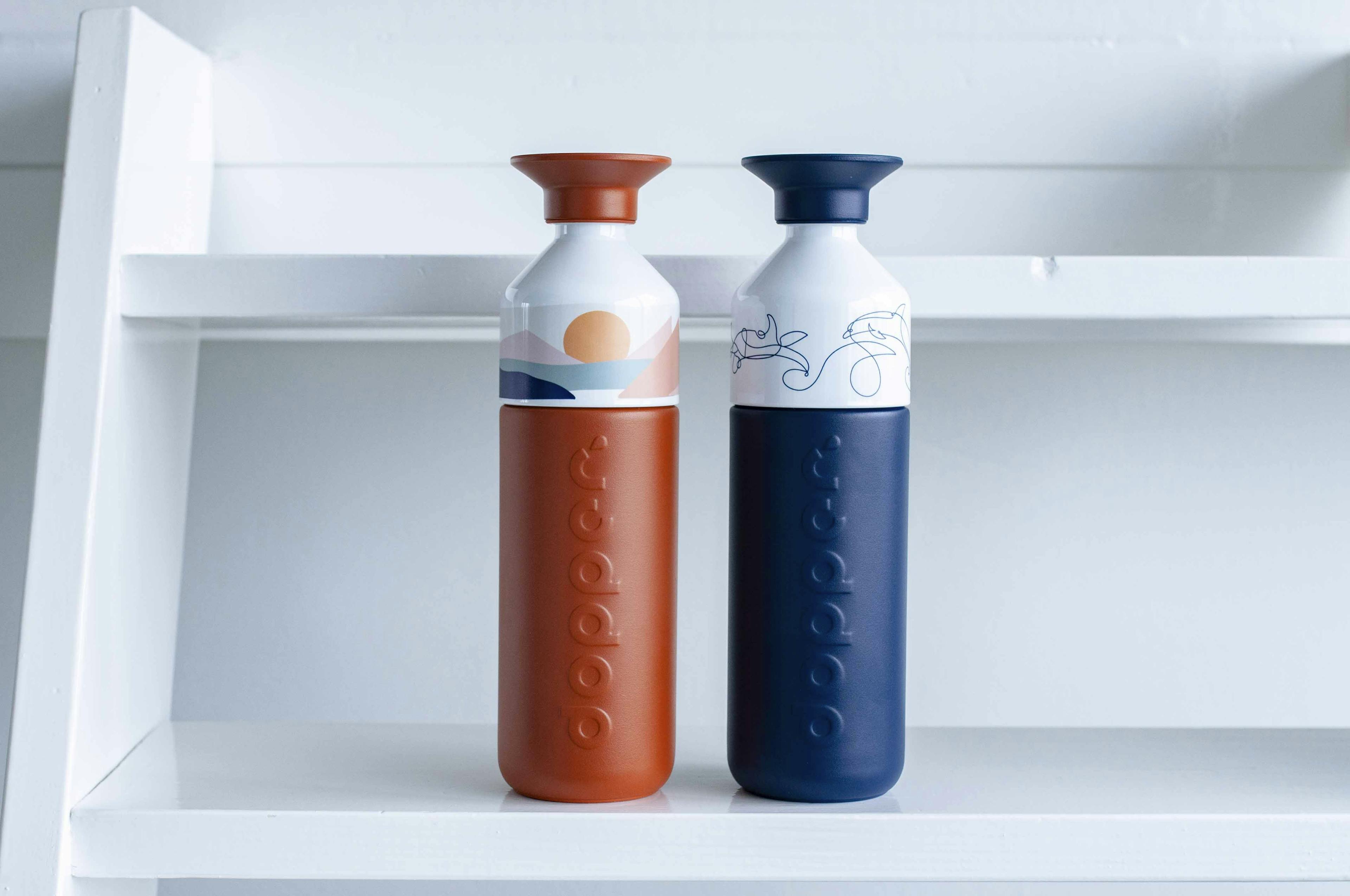 Two Dopper Insulated bottles on a white staircase